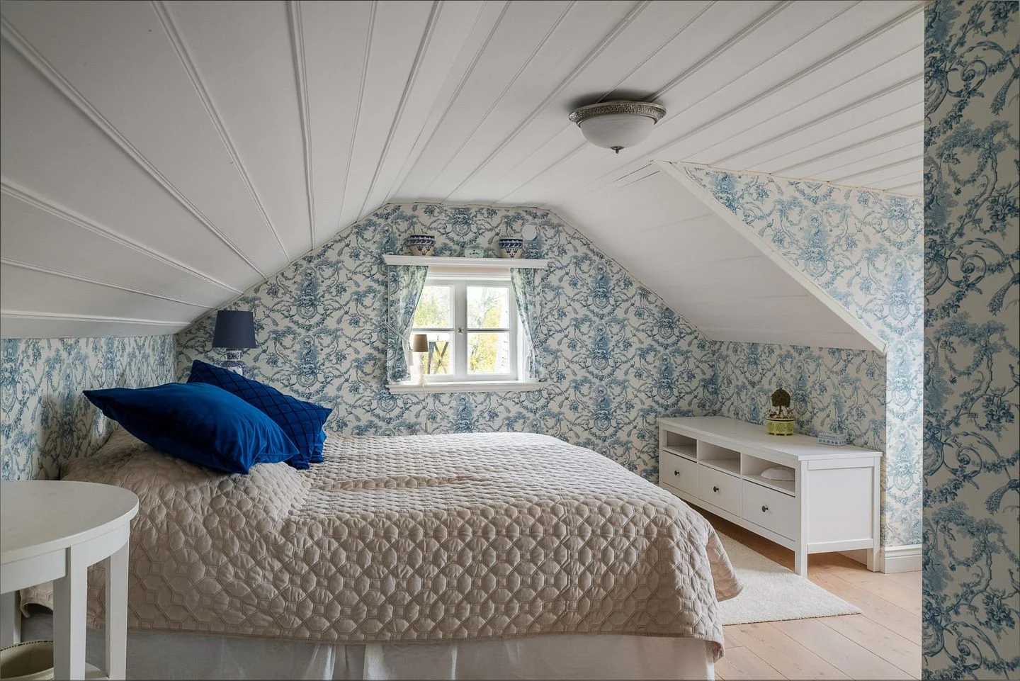 The Salen Room — tile stove, linen, fish-bone parquet